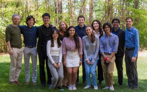 Faculty and students smiling.